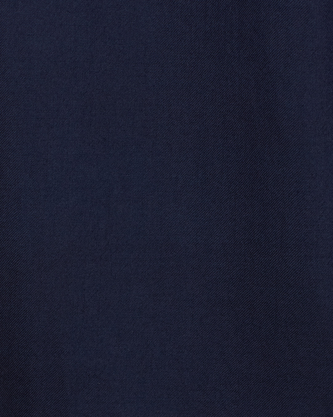 Close-up of the Rivoli Midnight Mischief Coat’s dark blue wool fabric, showcasing its subtle diagonal weave pattern and smooth texture.
