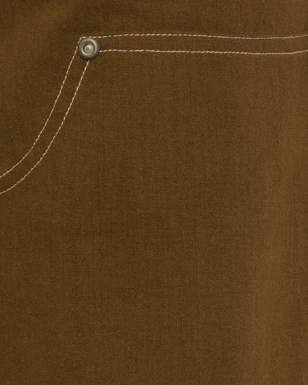 Close-up of the Scottie Olive Branch Pant’s brown workwear fabric, featuring a pocket with white stitching and a metal rivet in the corner, reminiscent of classic painter pant construction.