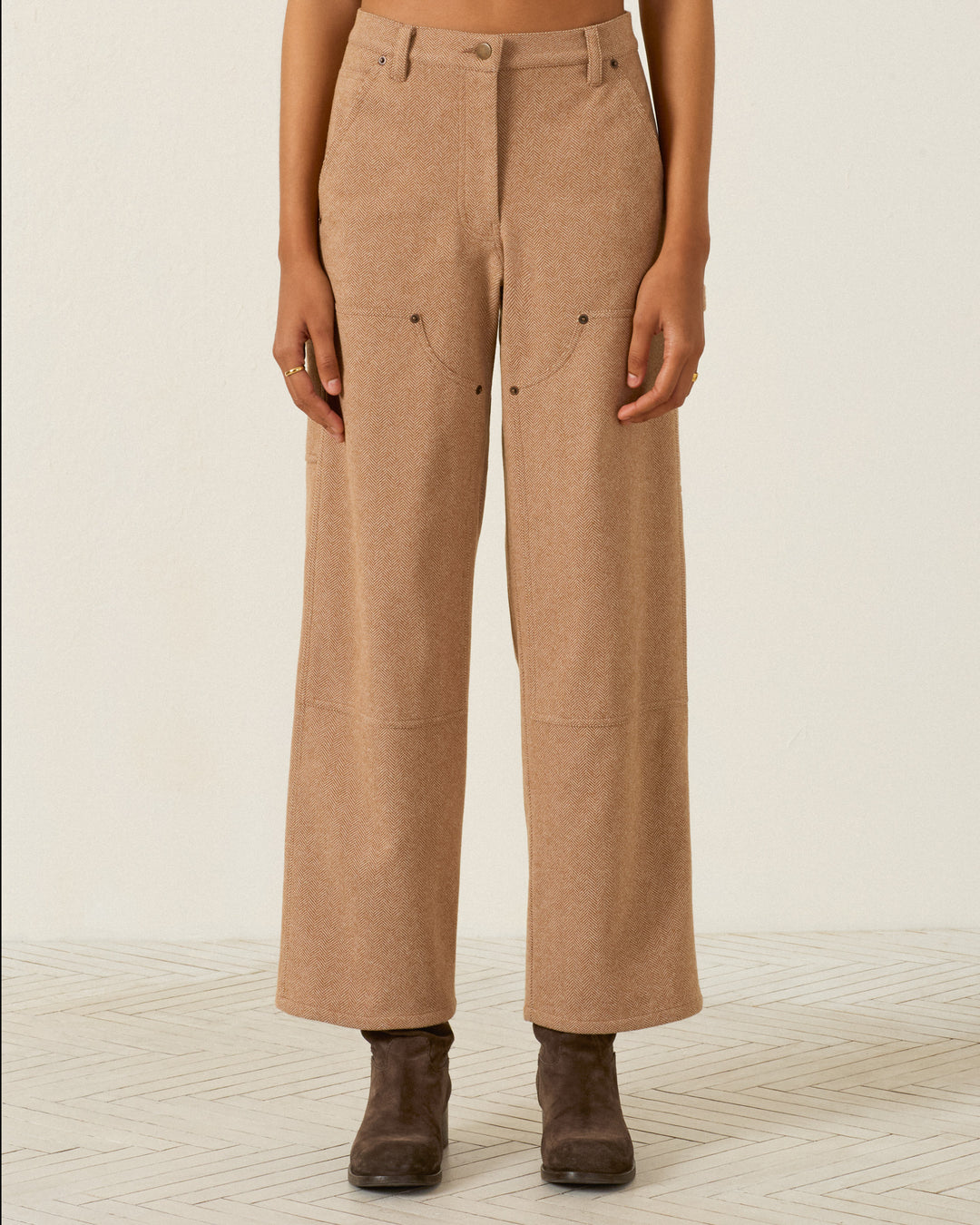Scottie Savanna Sand Pant in tan, featuring a high-waisted herringbone design with front utility pockets and reinforced knees, worn with dark ankle boots.