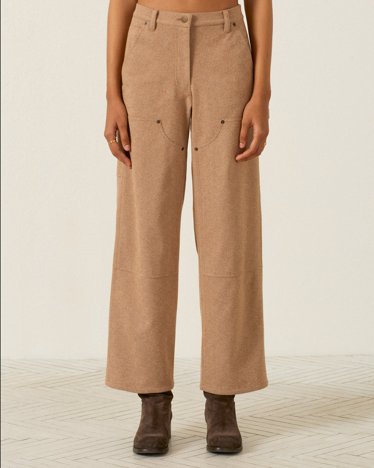Scottie Savanna Sand Pant in tan, featuring a high-waisted herringbone design with front utility pockets and reinforced knees, worn with dark ankle boots.