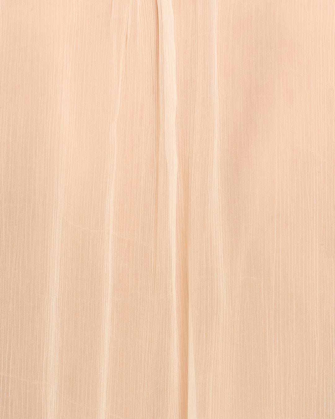 Close-up of the beige, semi-sheer cupro-chiffon fabric of the Willa Prairie Tint Shirt, featuring vertical textured lines and a subtle central crease, evocative of fine craftsmanship.