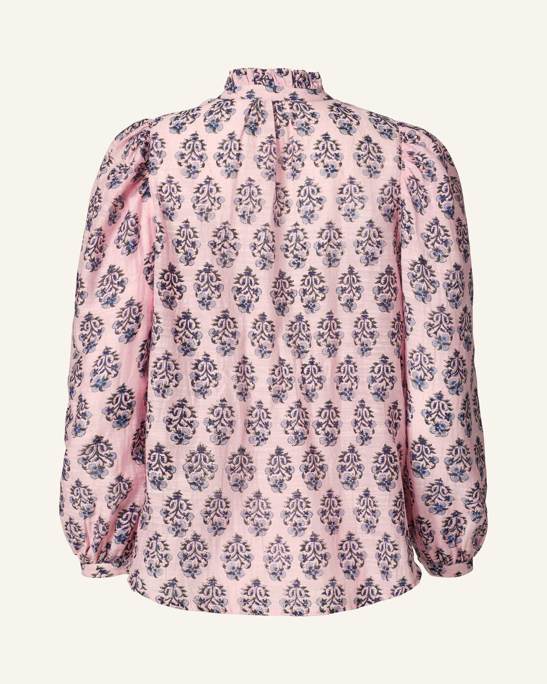 The Annabel Pink Lily Shirt is crafted from hand-printed silk, showcasing a pink and blue floral pattern. It features long sleeves with gathered puffed details, a high ruffled collar, and offers a loose fit at the back. The fabric has a light feel with subtle texture.