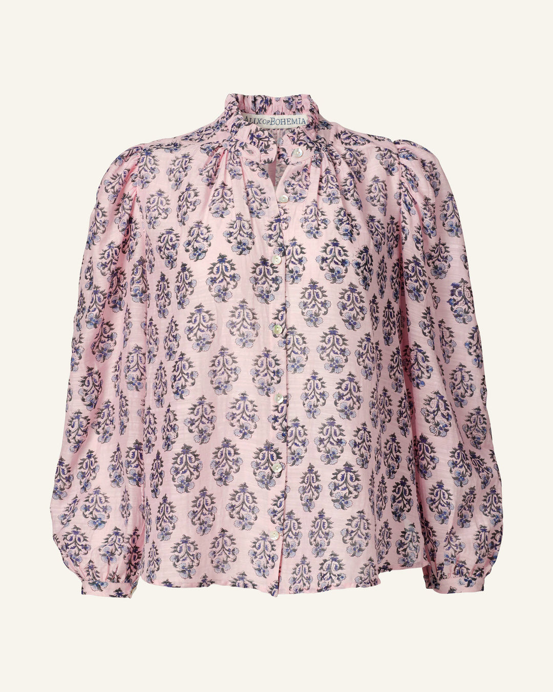 Introducing the Annabel Pink Lily Shirt: This elegant pink blouse boasts a ruffled high collar and long puffed sleeves. Made from hand-printed silk, it displays a symmetrical floral pattern in captivating shades of blue and purple. With its front buttons and relaxed fit, this shirt is a perfect blend of style and comfort.