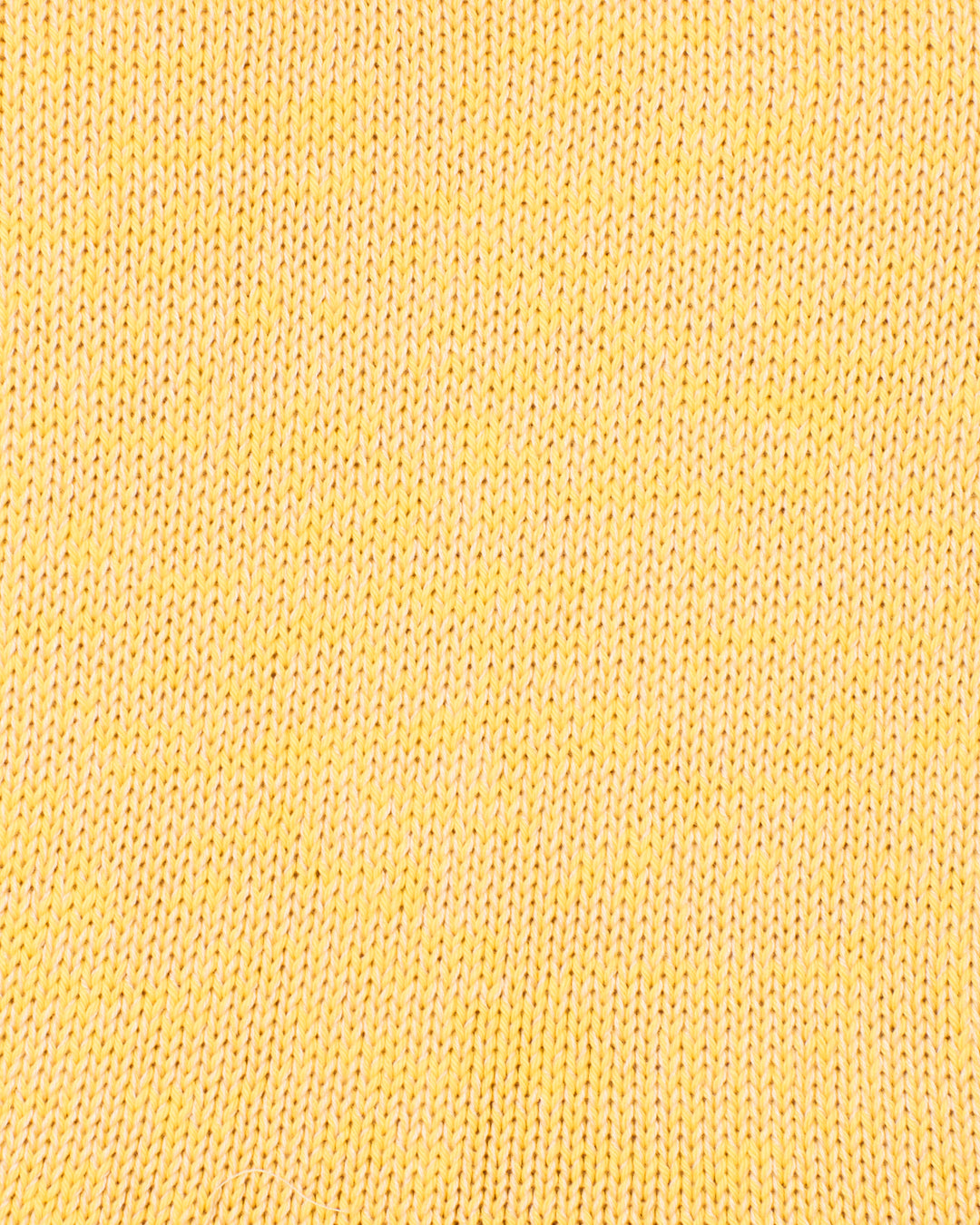 Close-up of the Ansel Sunglow Knit Top, showcasing its yellow cotton blend fabric and detailed stitch pattern.