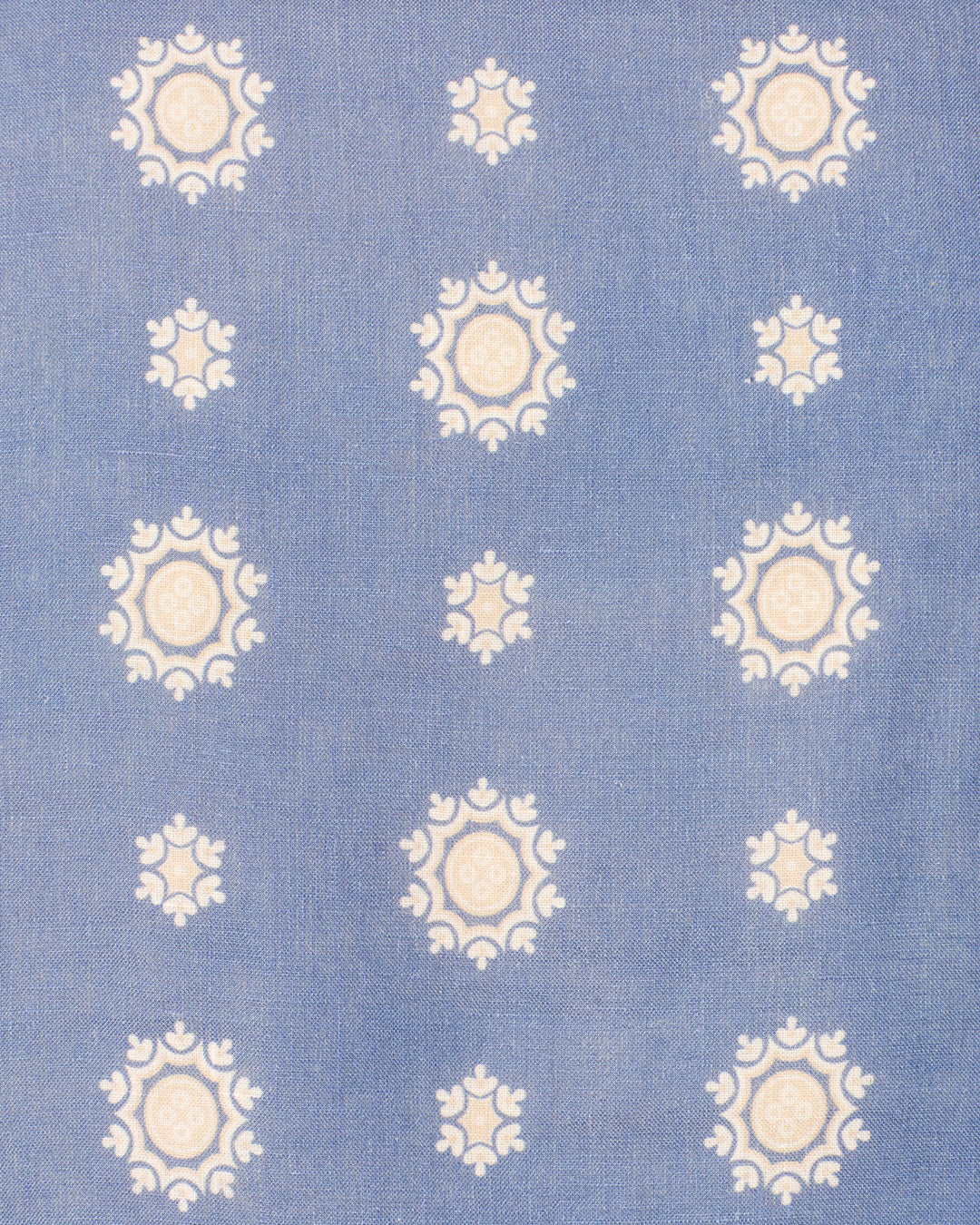 The Dorian Marina Bandana Jacket features blue fabric with white and beige floral circular motifs in vertical columns—perfect for a cropped bandana-print look or as an accent to a linen jacket with handmade cowrie buttons.