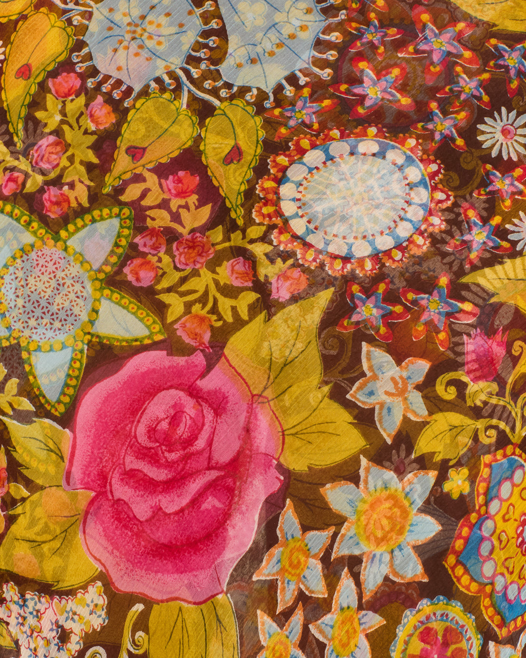 The Athens Bloom Mirage Dress features a colorful floral motif with a large pink rose, stylized flowers, and green leaves on a brown background with intricate details—perfect for a bias-cut slip dress.