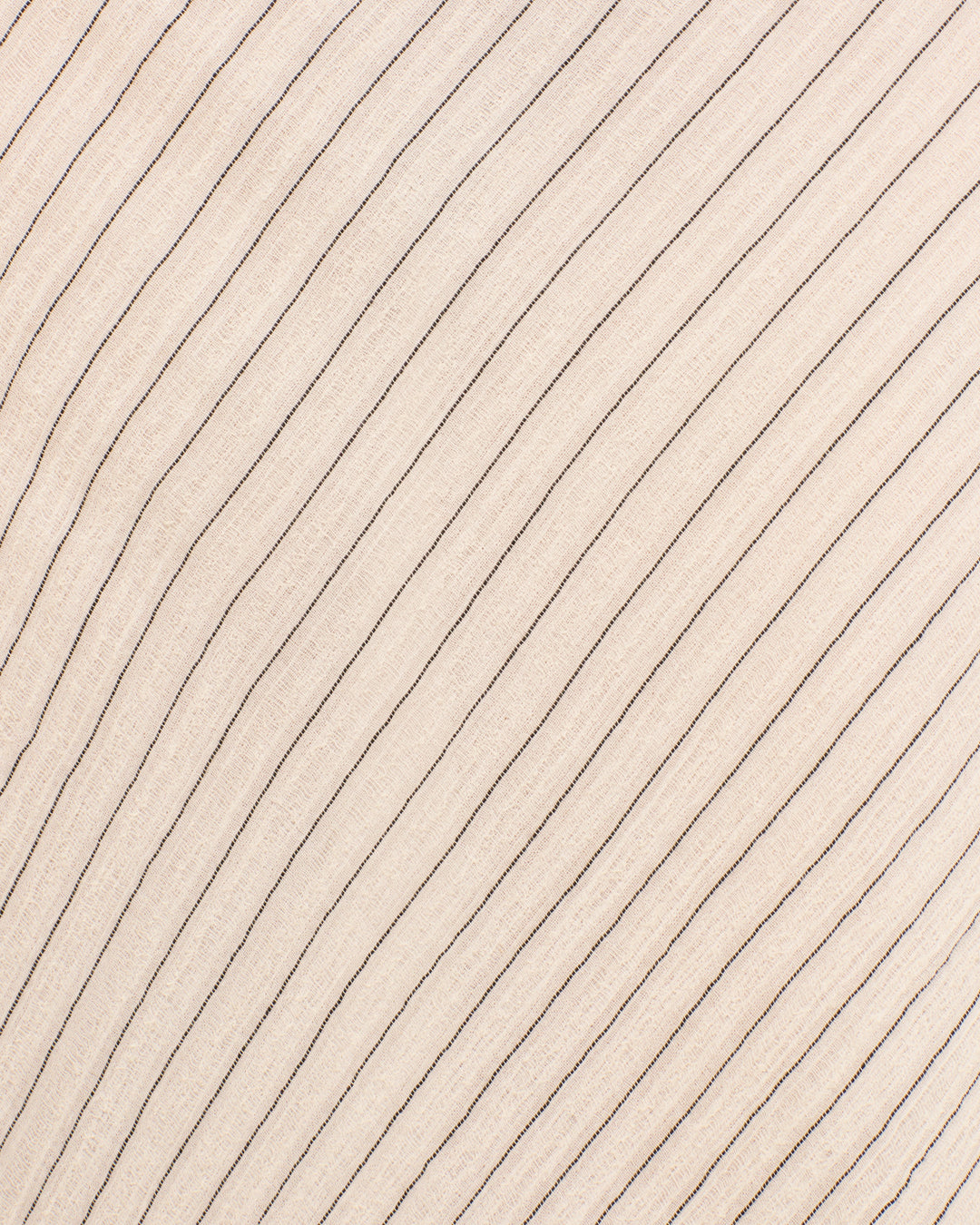 Close-up of the Athens Sea Salt Dress in light beige, featuring evenly spaced, curved parallel lines that mimic yarn-dyed stripes on soft gauzy cotton.
