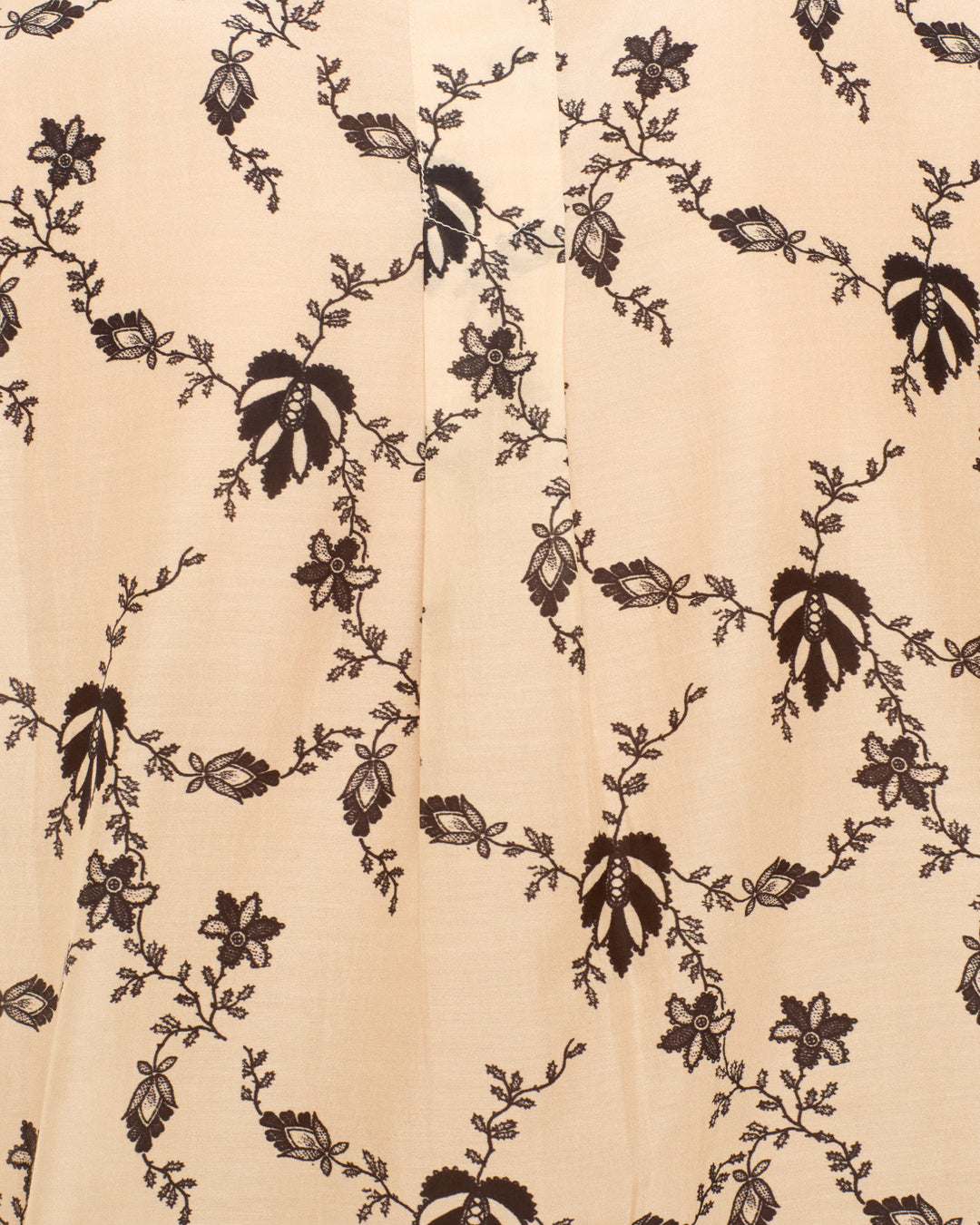 Chance Shadow Lace Shirt, a light peach cropped blouse with a repeating dark brown floral vine print.