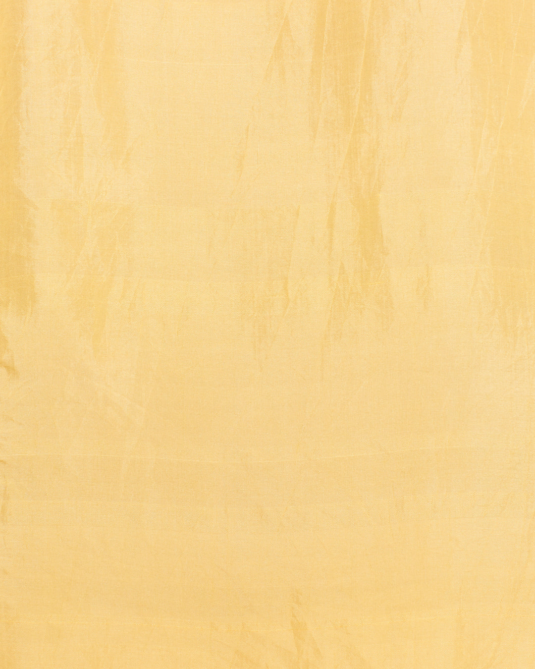 The Dana Sunlight Silk Shirt features a plain yellow fabric with a subtle sheen and visible creases, evoking the look of hand-loomed silk.