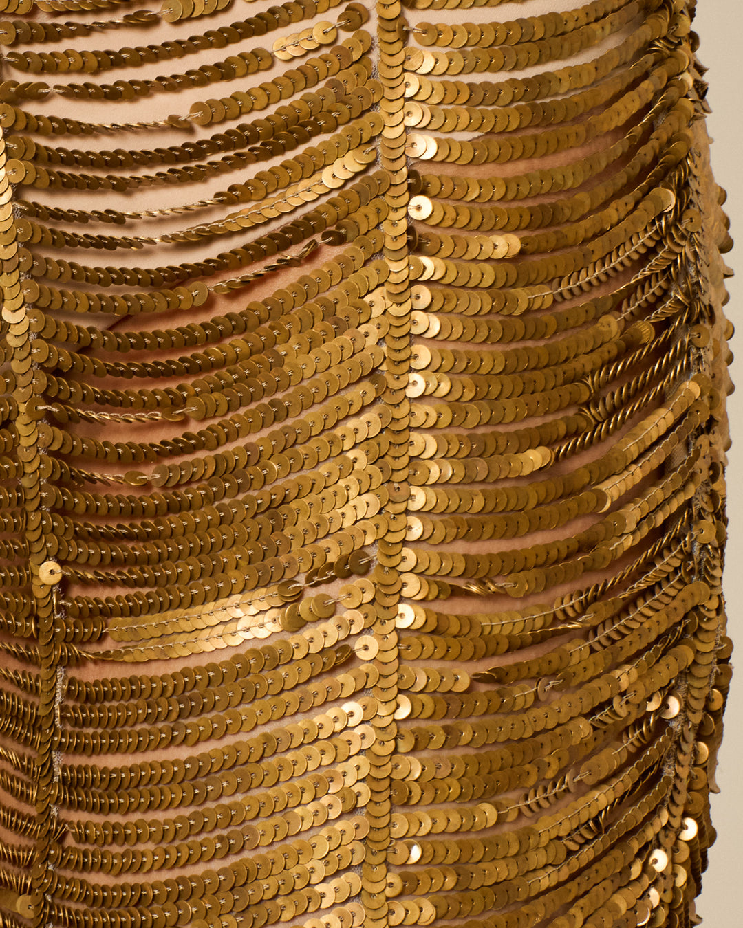 Close-up of the Deena Bronze Coin Short, hand-crafted with dense rows of shiny bronze sequins for a textured, reflective look—ideal as metallic festival wear.