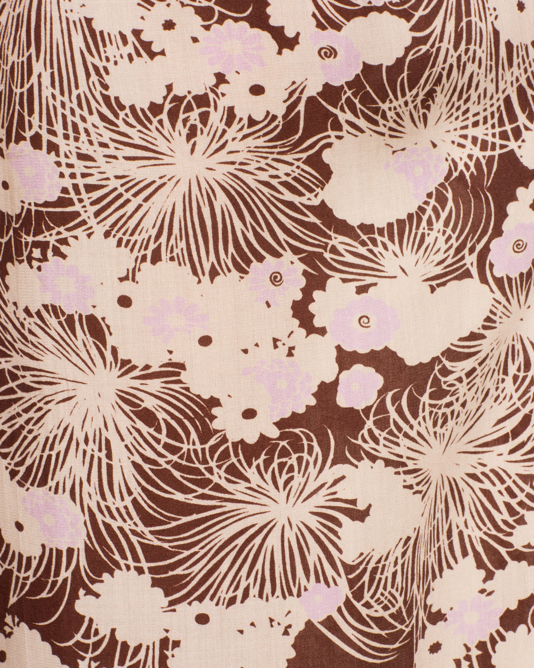 The Margie Dandelion Dusk Pant is crafted from brown Tencel fabric adorned with an abstract cream and light pink floral motif featuring radiating lines and cloud-like shapes—perfect for creating a relaxed wide-leg silhouette.