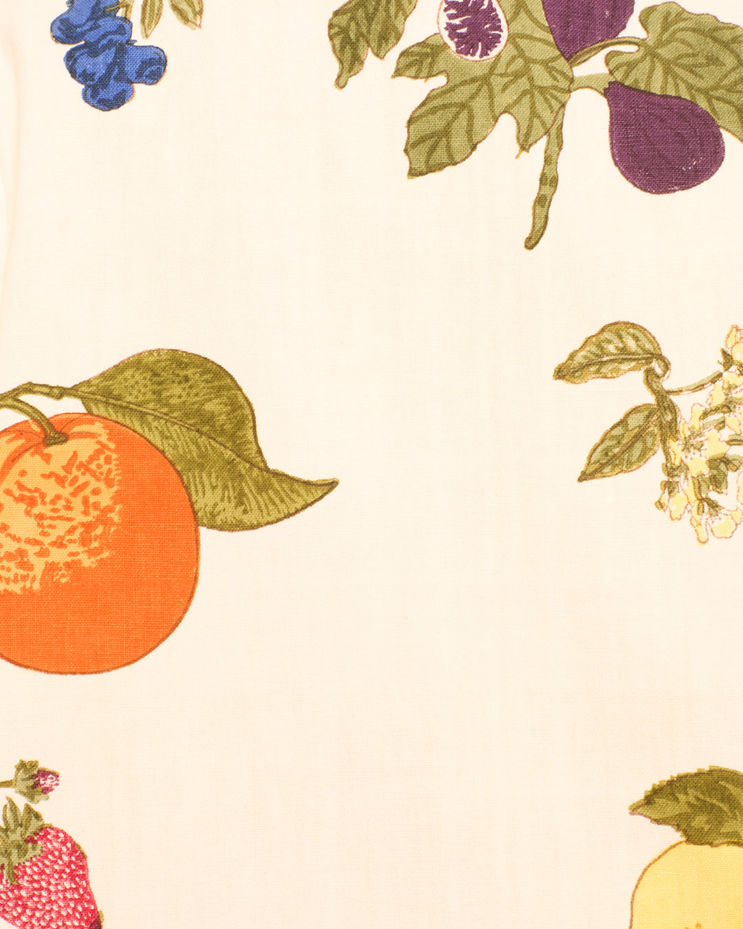 Hand-block-printed on a light cream background, the Western Nine Fruit Jacket features colorful illustrations of various fruits, including an orange, plum, strawberry, grapes, and lemon.