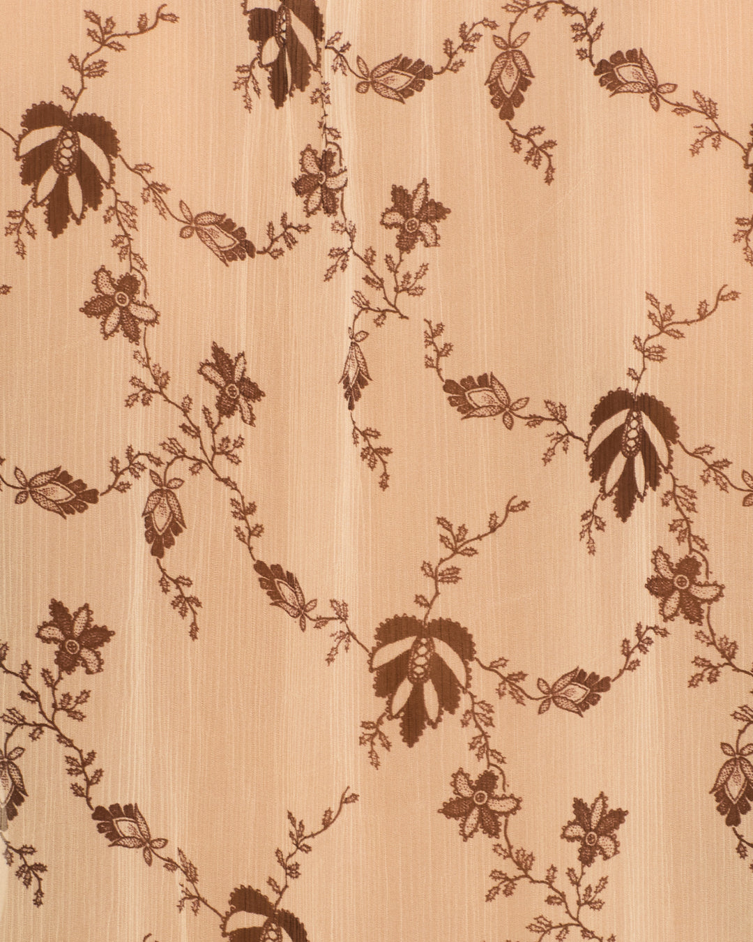 The Willa Shadow Lace Shirt features beige fabric with vertical stripe texture and a repeating dark brown floral and vine pattern inspired by lace motifs.