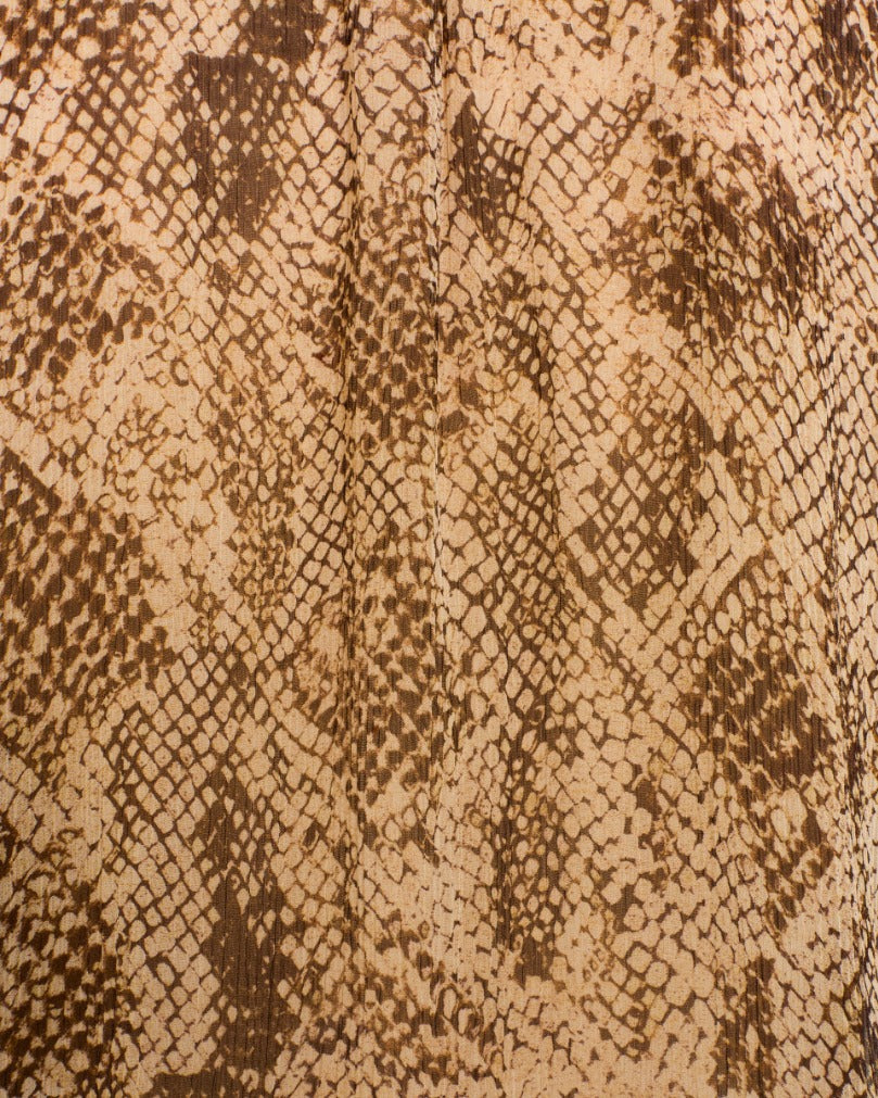 Close-up of the Poet Lemon Snakeskin Blouse, featuring vintage-inspired fabric with a brown and beige snakeskin pattern, scale-like shapes, and textured details—evoking the subtle elegance of a classic snakeskin-print shirt.