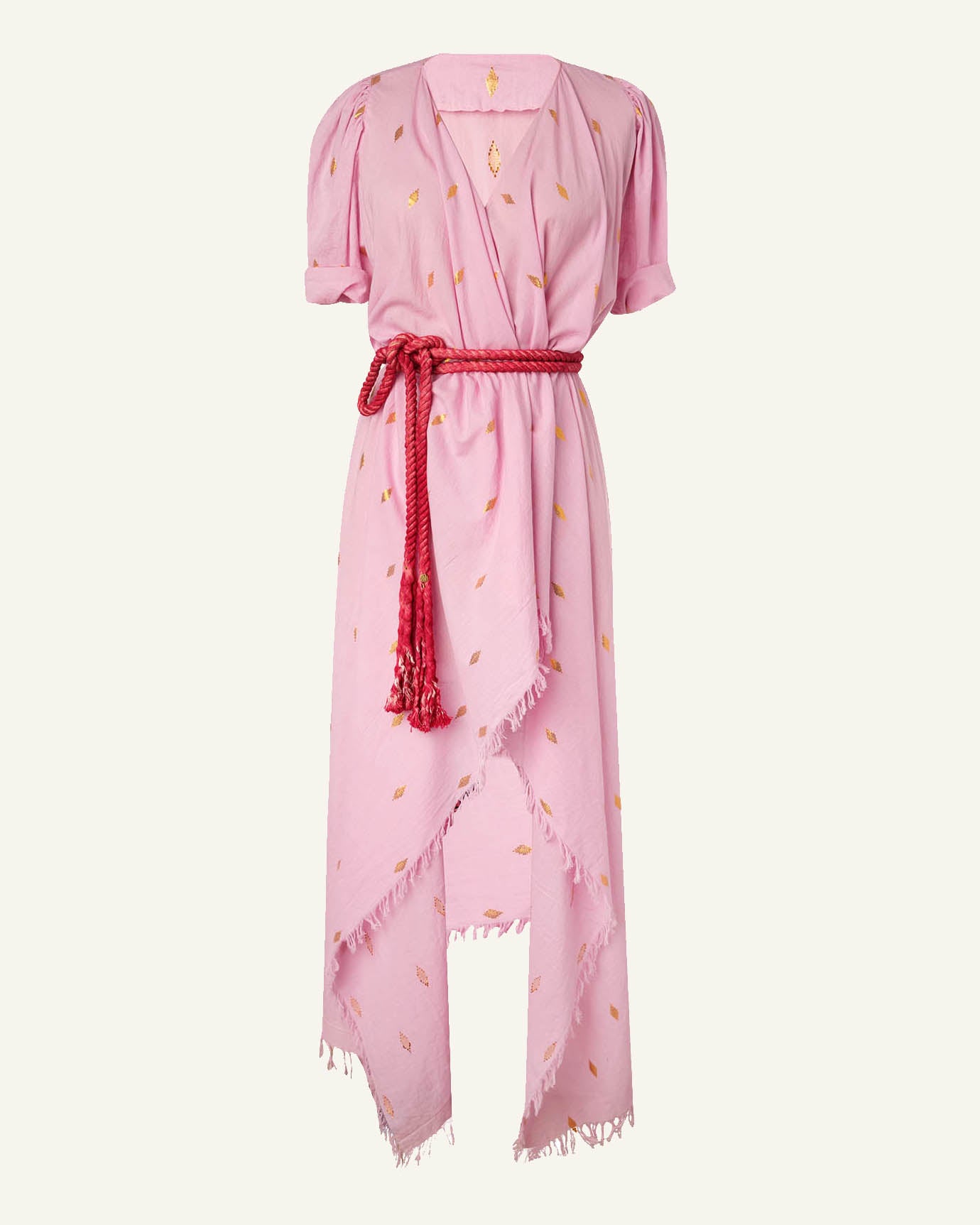 The Persephone Pink Jamdani Dress showcases short sleeves and gold leaf patterns, featuring an asymmetrical hem with fringe details. It is elegantly cinched at the waist with a red rope belt, enhancing its distinctive design.