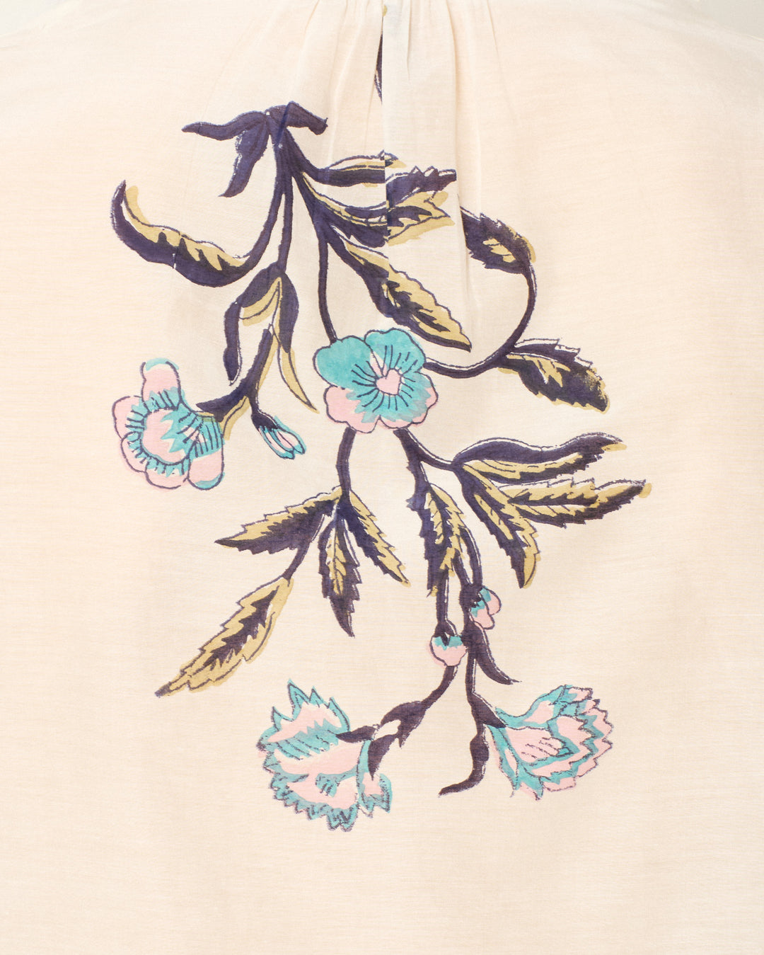 The Annabel Misted Lily Shirt features an embroidered floral motif in blue, teal, and yellow threads on a light beige cotton-silk blend.
