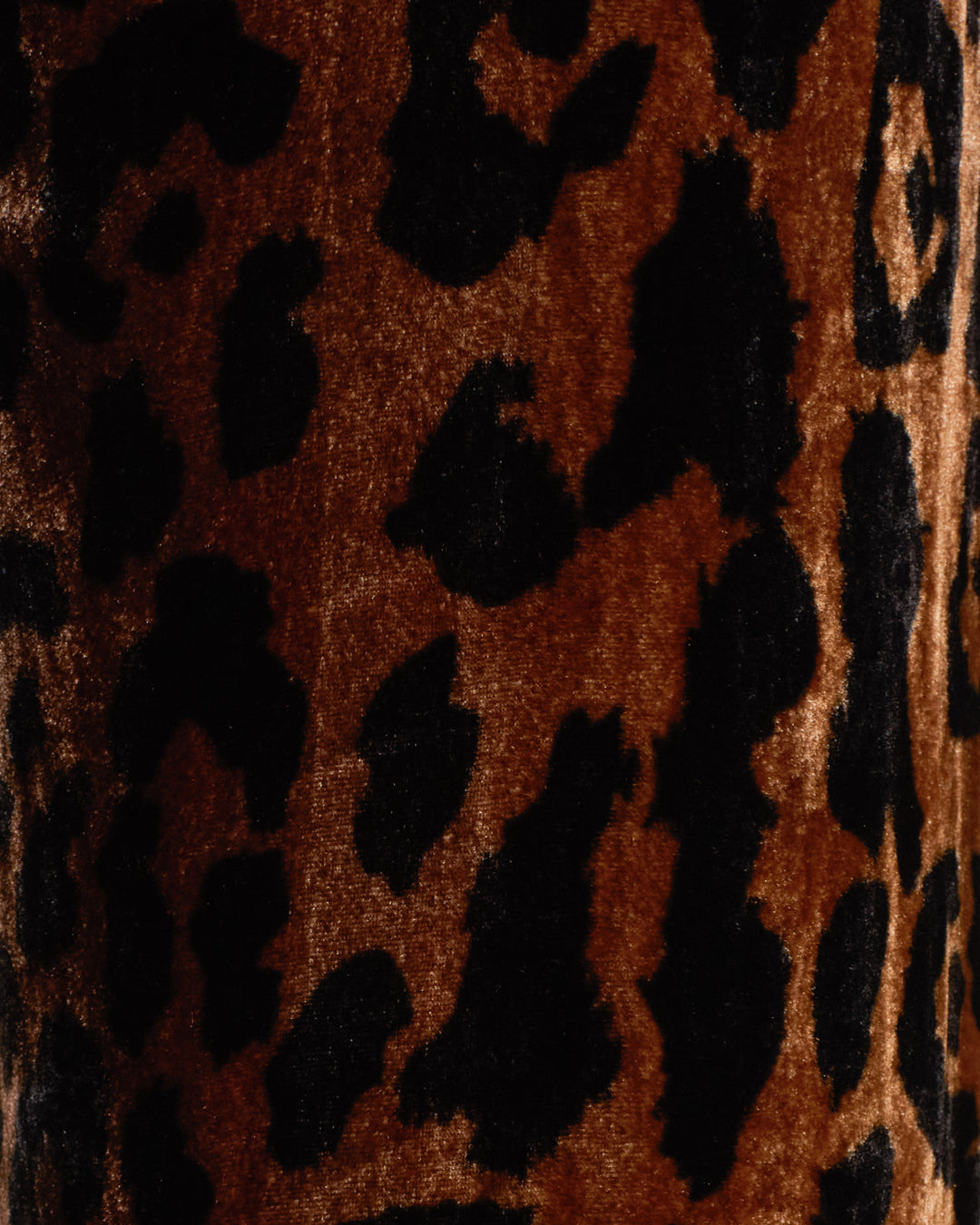 Close-up of the Farah Leopard Velvet Pant, featuring irregular black spots on a brown and tan background that closely resembles animal fur.