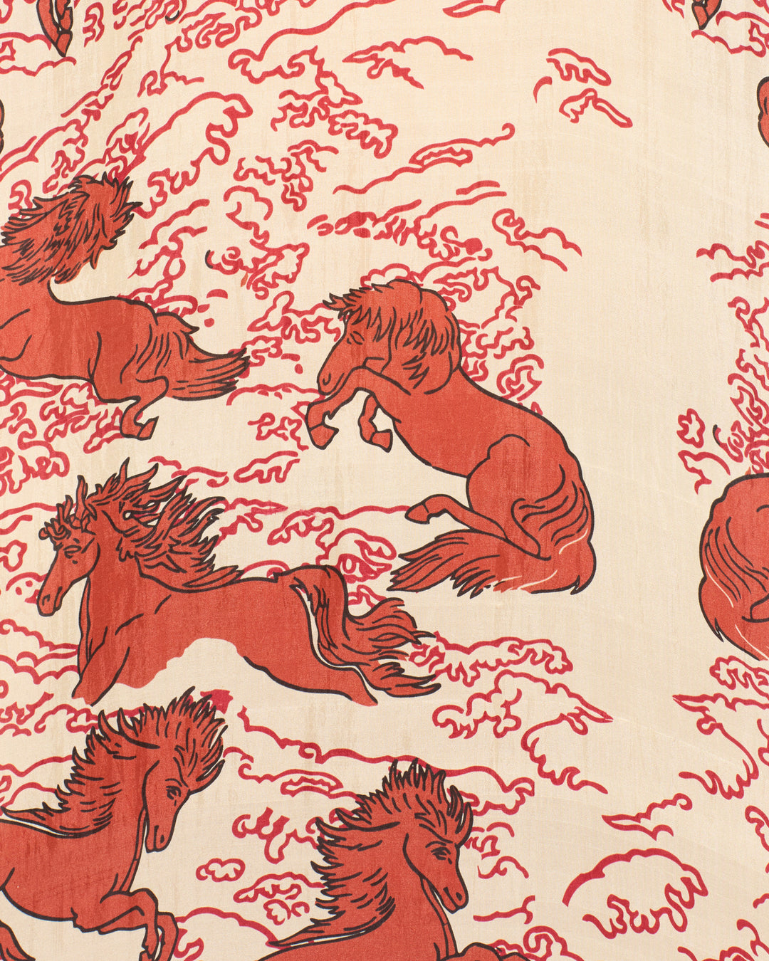 Red Pegasus horses in motion, set against a cream background with swirling lines, create a mythical motif that brings an enchanting flair to the artisan-made Emery Rouge Pegasus Shirt.