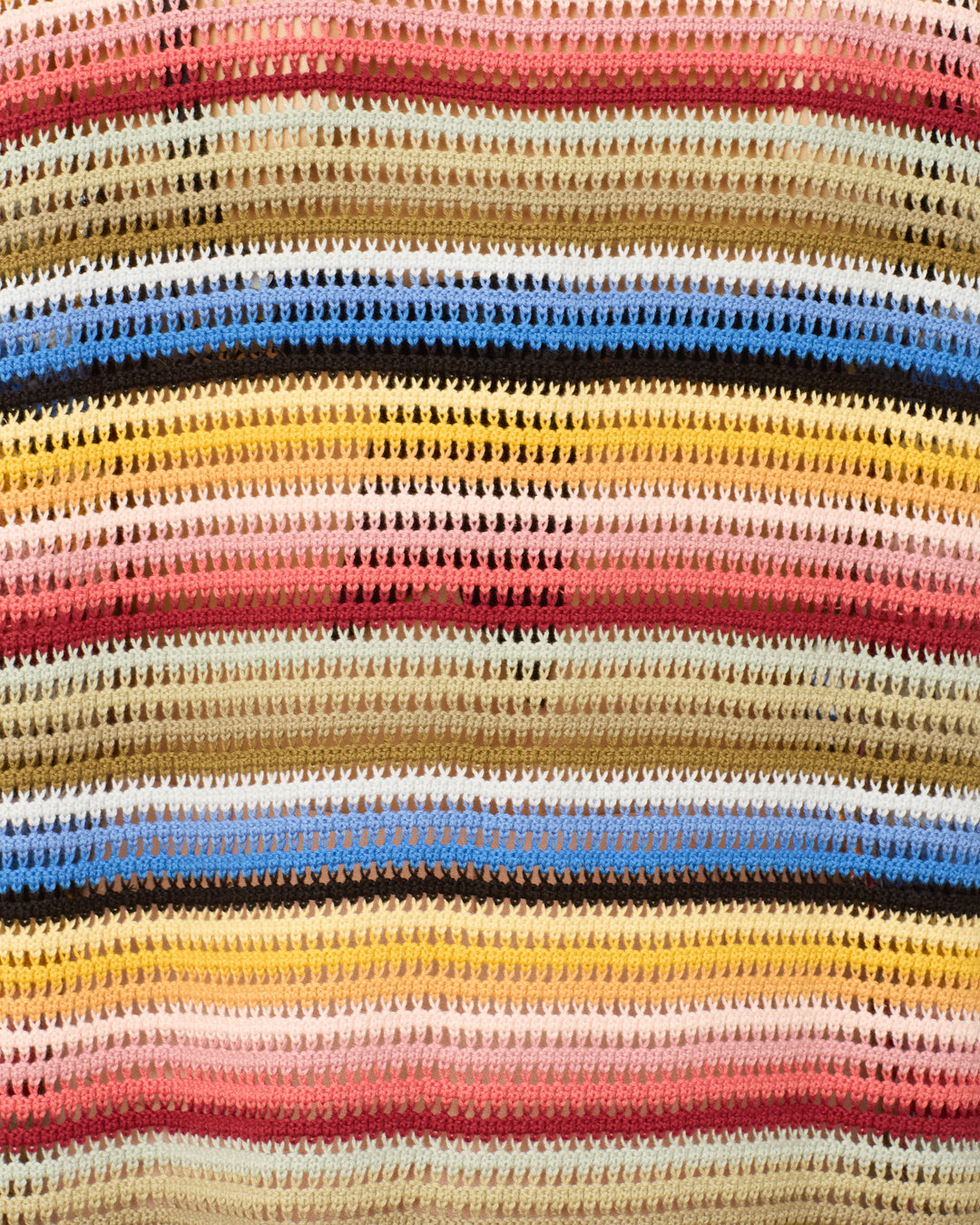 The Emery Ombre Crochet Top features a vintage ‘70s-inspired open-knit design with horizontal rainbow stripes in brown, pink, yellow, blue, and cream and a repeating textured pattern.