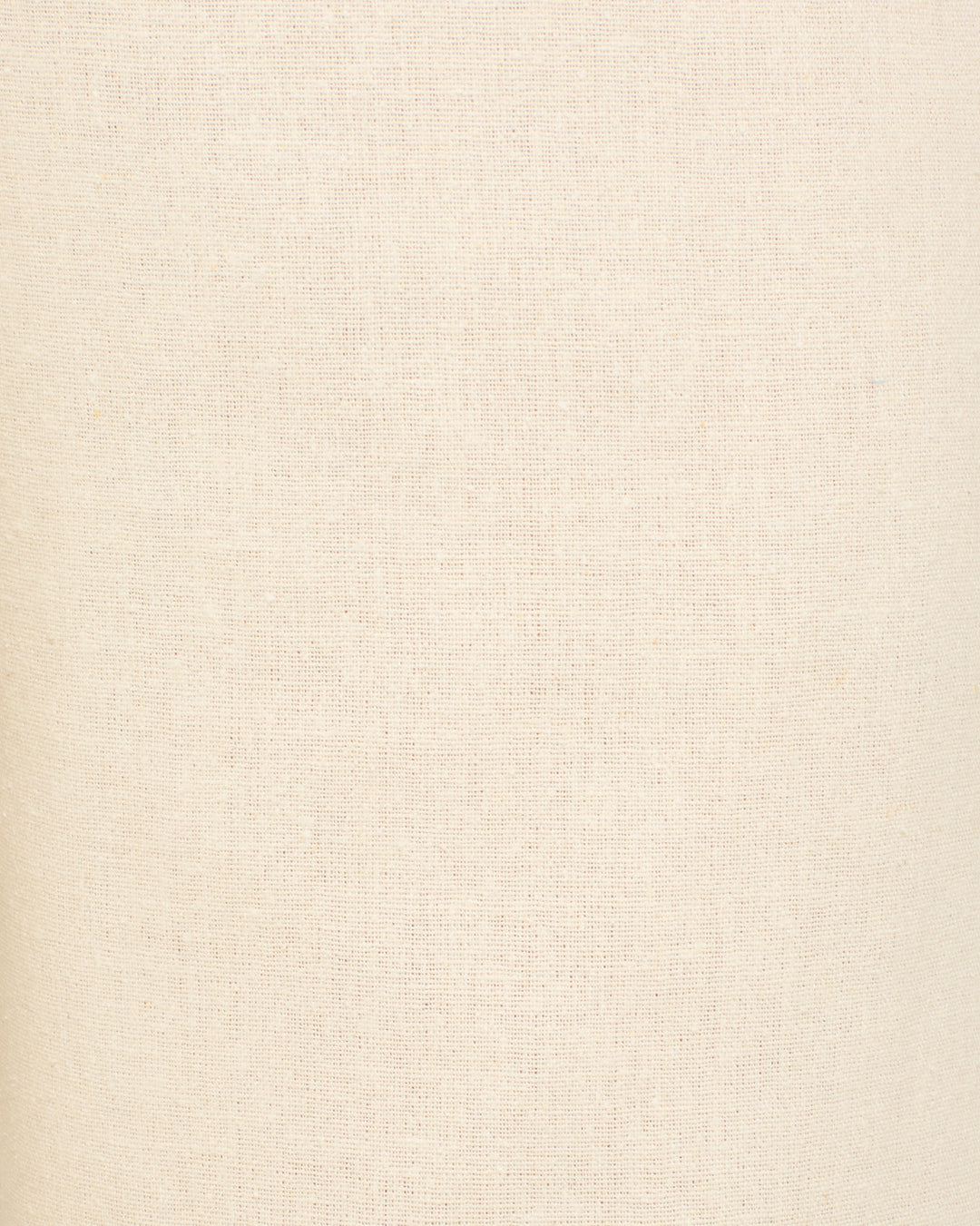Close-up of the Farah Alabaster Silk Pant’s plain, light beige fabric with a subtle woven texture—ideal for high-waisted silhouettes or elegant bell-bottom flares.