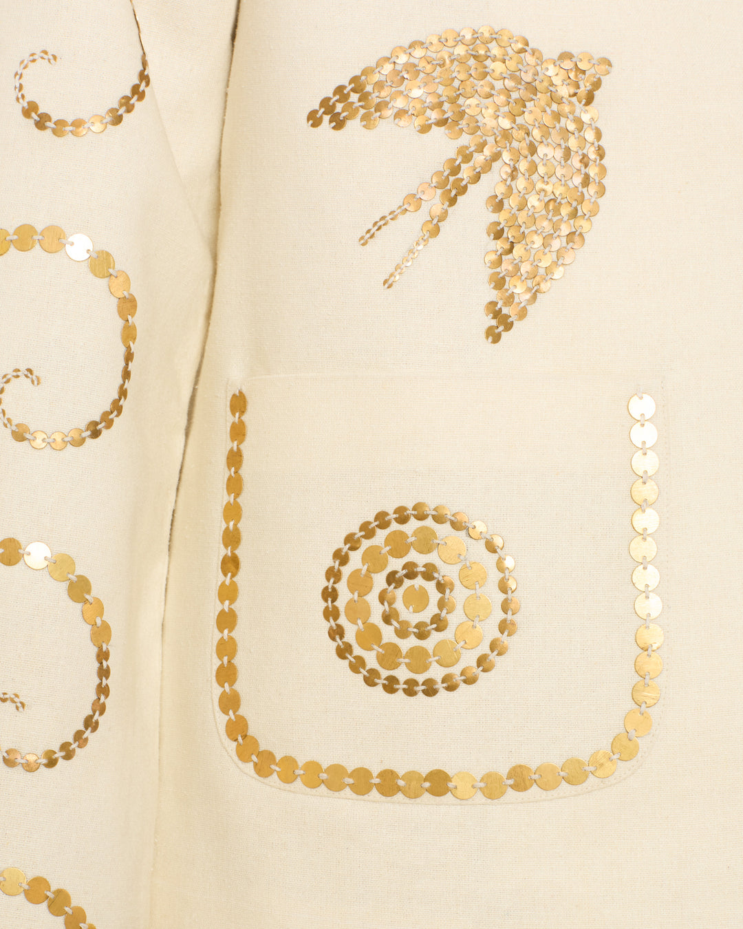Close-up of the Francis Pearl Nocturne Jacket, featuring cream-colored Klimt-inspired fabric with gold sequin decorations, a circular pattern on the pocket, and a bird-like motif above it.