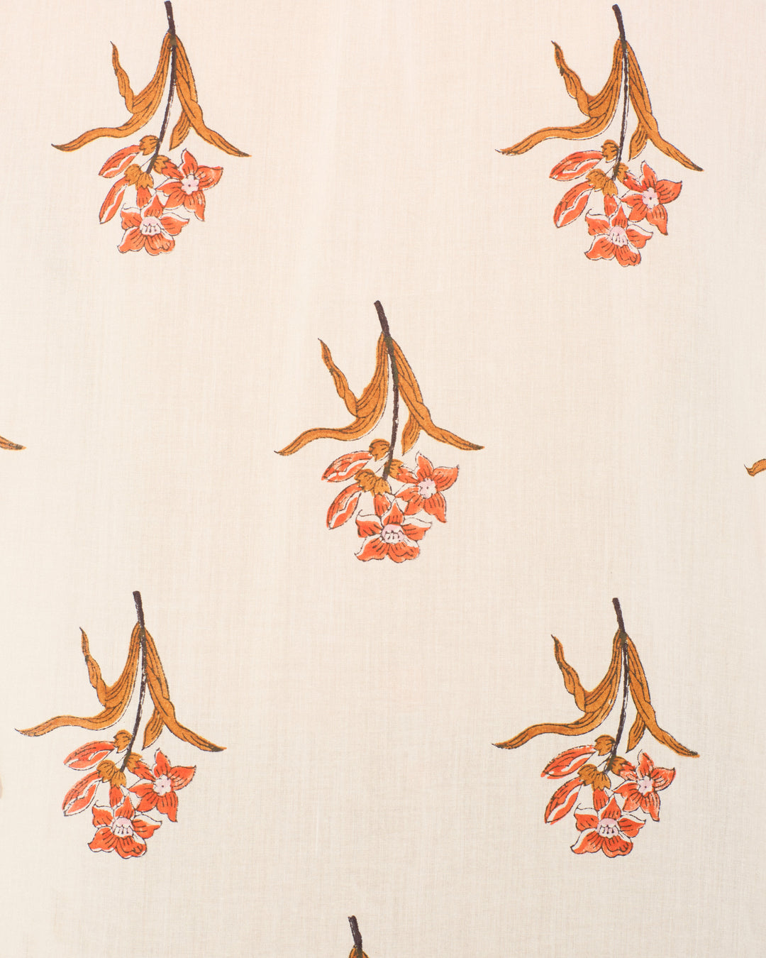 The Kiki Persimmon Flower Shirt is a beige cotton voile shirt with hand-block-printed orange flowers and brown leaves, evenly spaced for an Edwardian-inspired look.