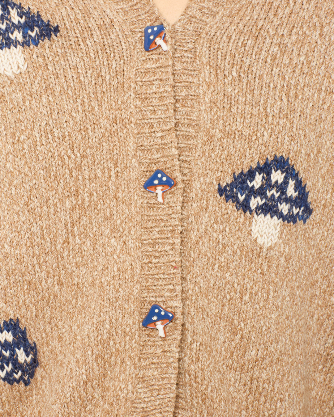 Close-up of the Sammi Champignon Knit Cardigan in beige baby alpaca, featuring blue and white mushroom motifs and red and white mushroom-shaped buttons.