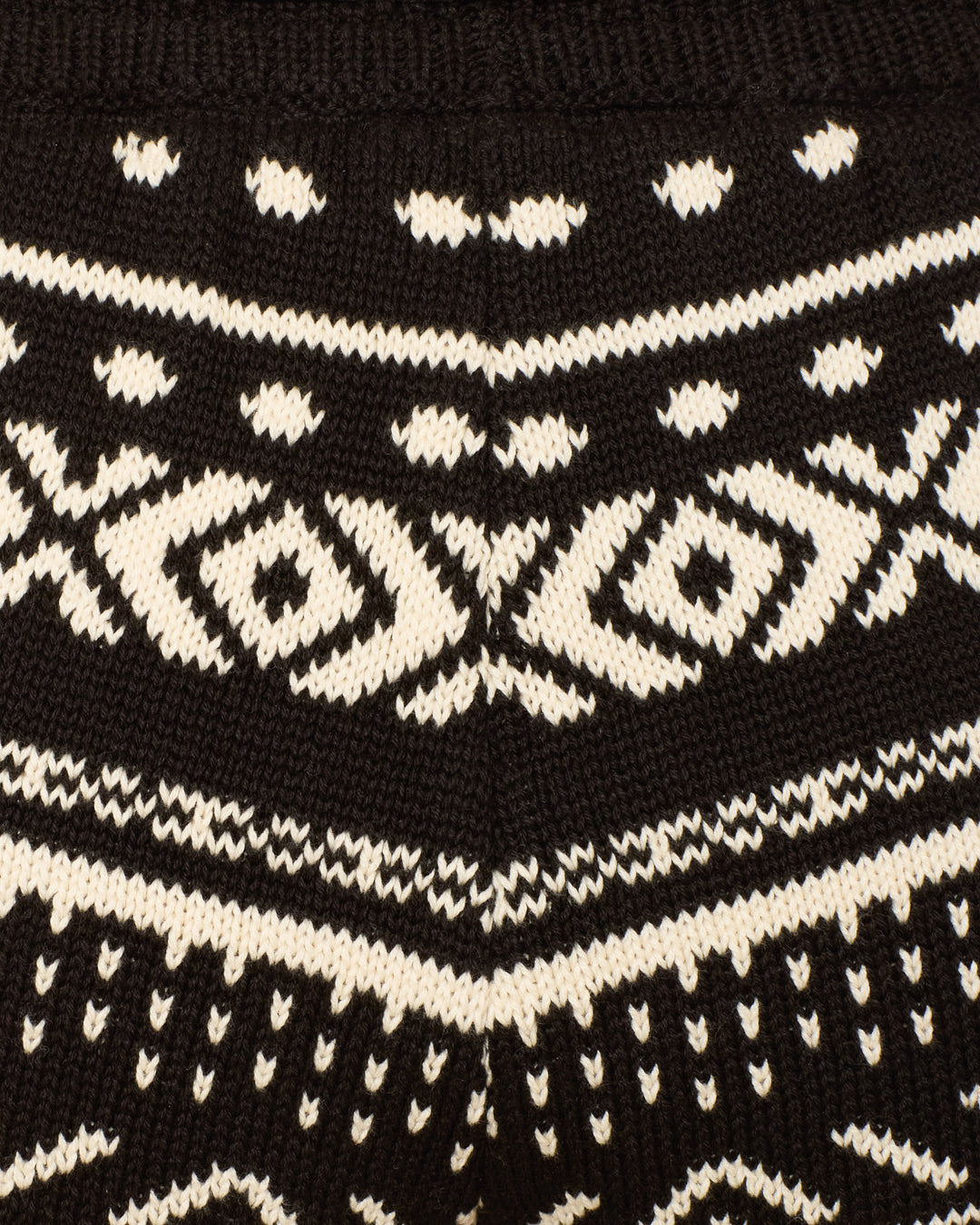 Close-up of the Shea Black Marble Short, featuring black knitted fabric with white geometric, symmetrical patterns—ideal for cozy winter loungewear.