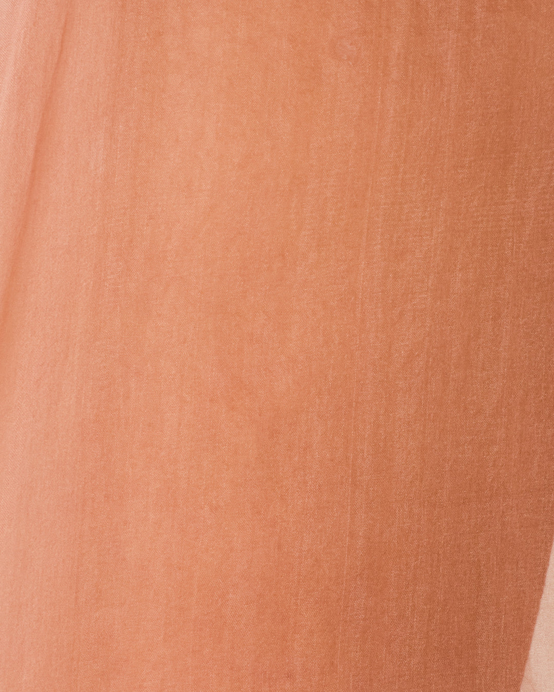 Close-up of peach-colored organza fabric with visible weave texture and subtle shading, capturing the elegant drape of the Diana Mocha Organza Pant.