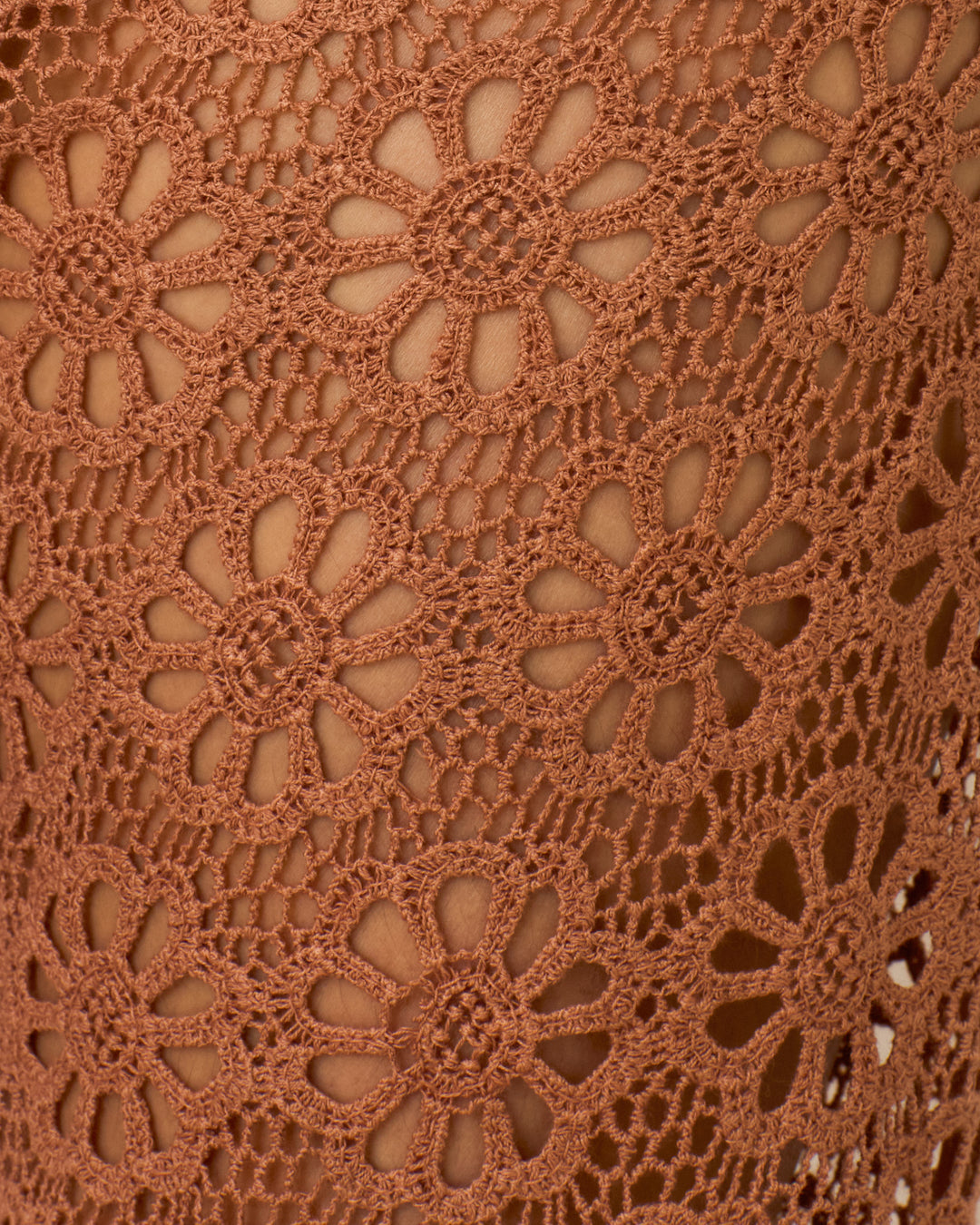 Close-up of the Farah Mocha Daisy Pant’s brown crochet fabric, showcasing daisy floral motifs and open spaces—ideal for adding charm to this cotton lace bell-bottom style.