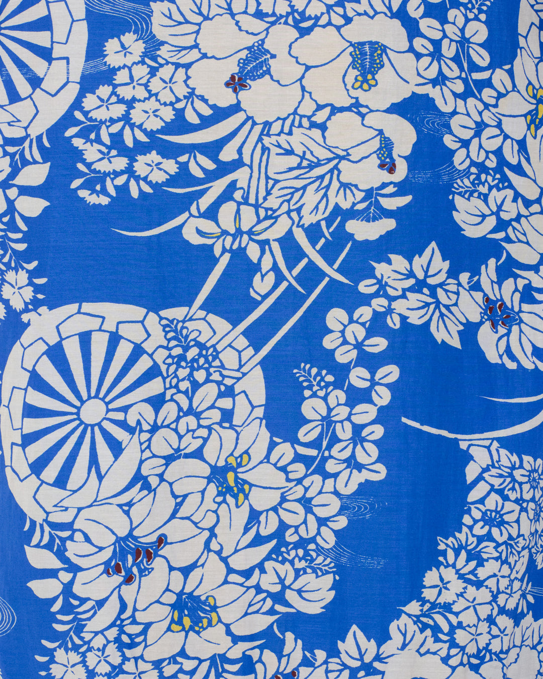 The Adele Royal Spoke Silk Dress features blue and white fabric adorned with a repeating floral and hanaguruma motif of detailed flowers, leaves, and stylized cartwheels.