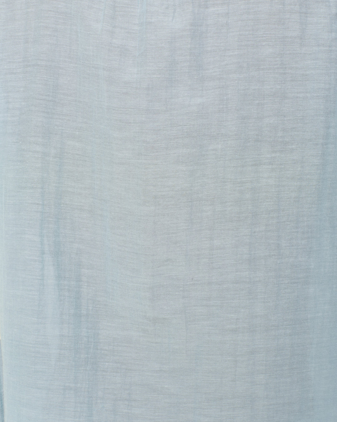 Annabel Sky Prima Lace Shirt features light blue textured fabric with subtle lines for a soft, woven look—ideal for styles like ruffled collars or elegant puff shoulders.