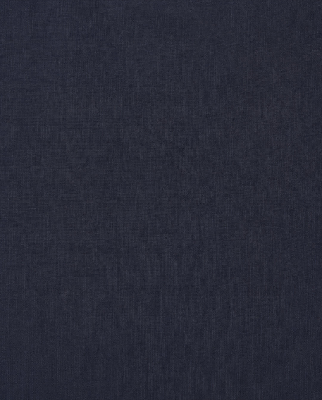 A dark navy blue fabric surface with a subtle, fine texture extends across the entire image—evoking the refined materials featured in the Artemis Deep Sea Shirt and its delicate puff sleeves.