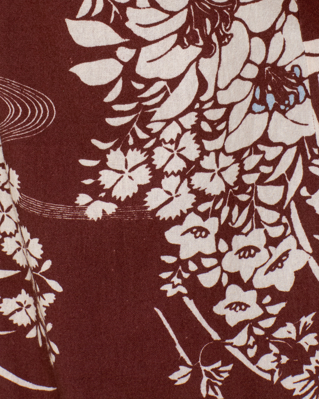 The Bunny Auburn Spoke Jean showcases maroon Khadi cotton with white floral and leaf designs, detailed blossoms, curved lines, and a subtle hanaguruma motif.