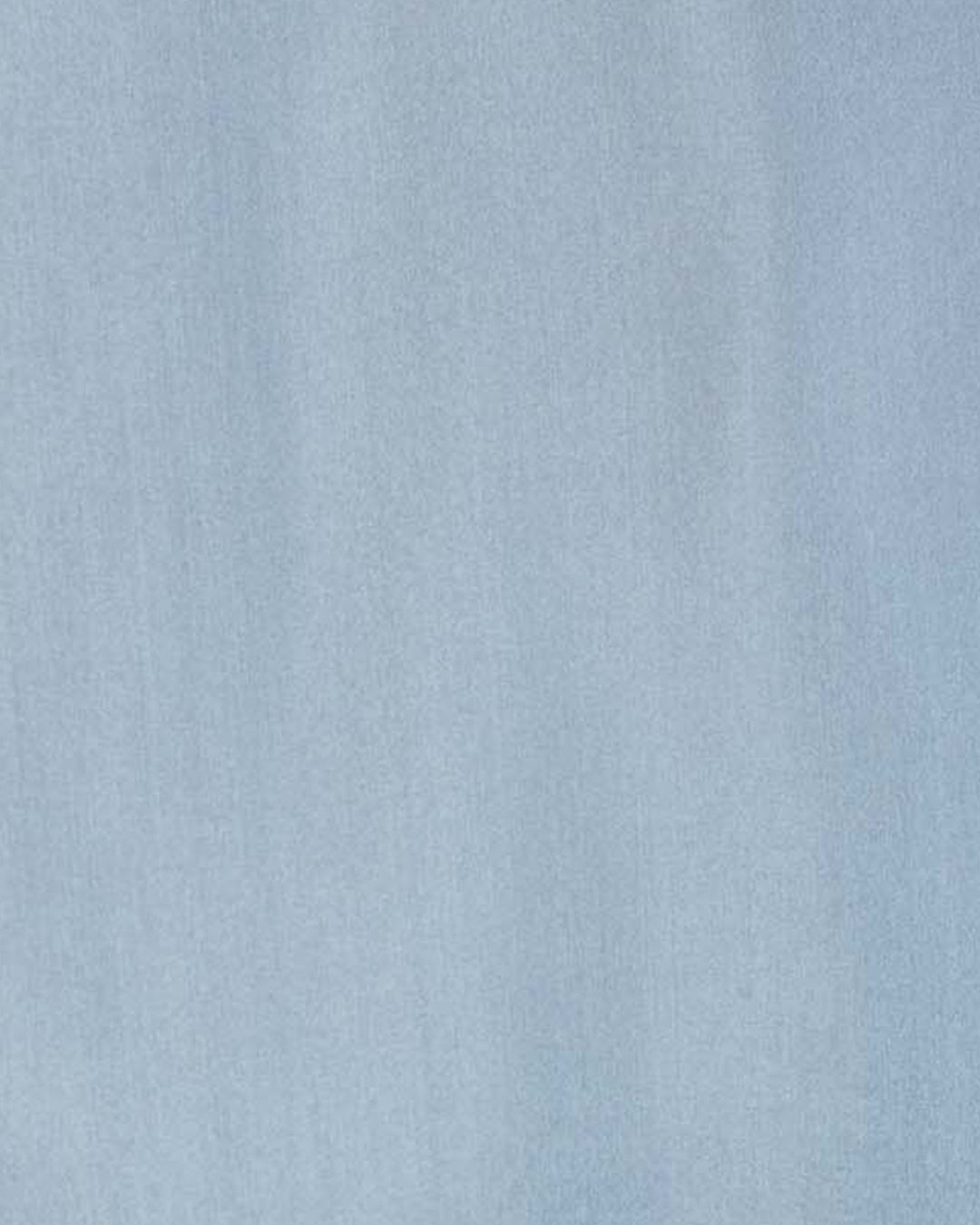 Crafted from light blue textured fabric with subtle vertical lines and soft shading, the Dana Chambray Silk Shirt evokes the look of hand-loomed silk, creating a gentle gradient effect across its surface.