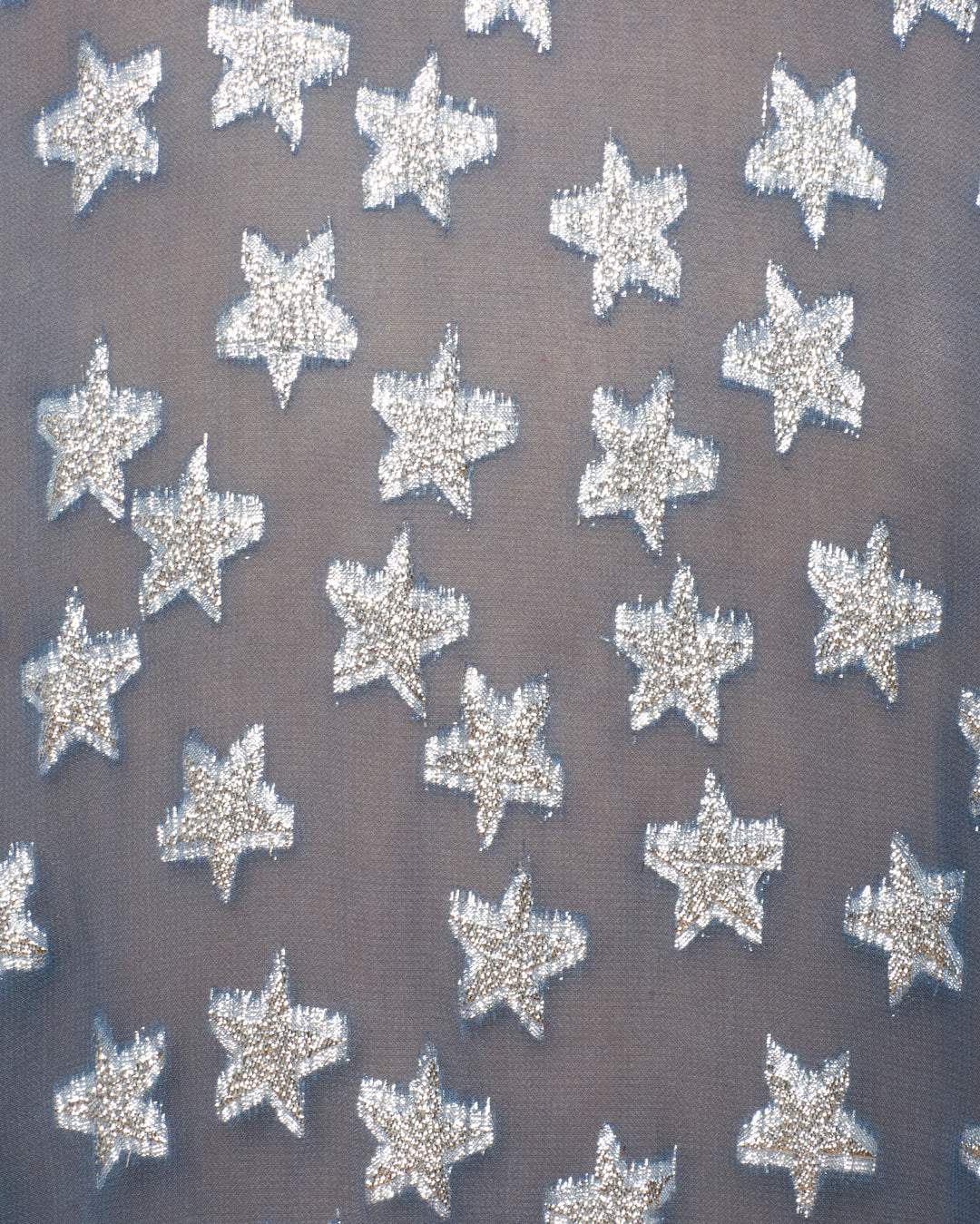 Close-up of metallic silver fil-coupé sequin stars embroidered on the sheer, light gray viscose-chiffon Emery Starlite Shirt.