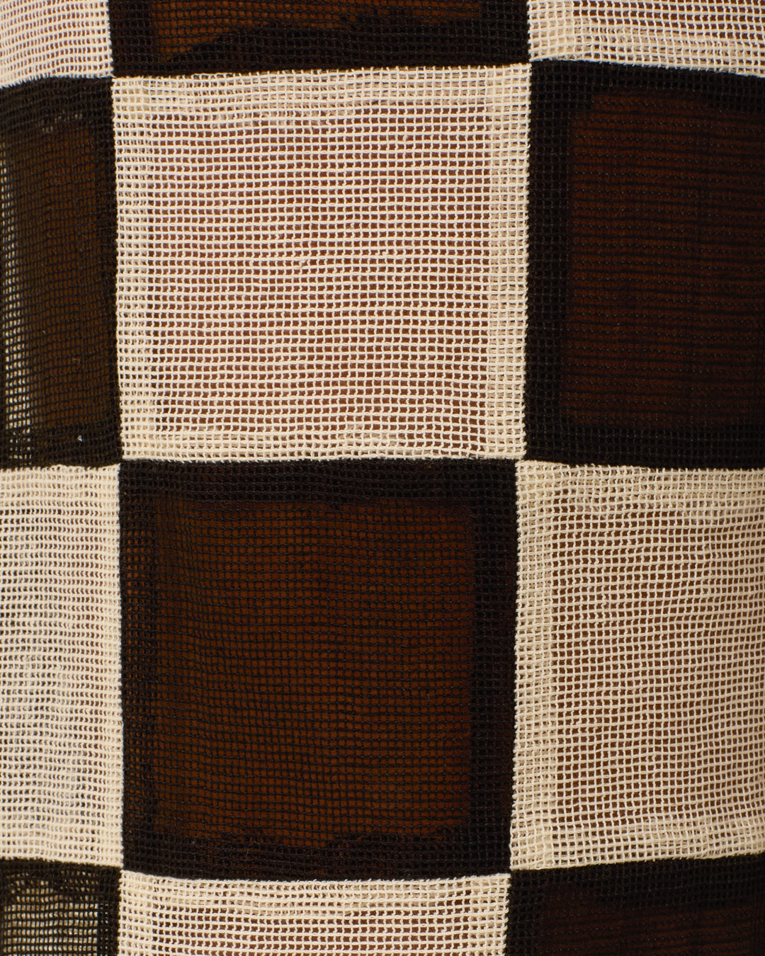A close-up of the Farah Harlequin Pant's semi-sheer cotton fabric, featuring a black and white checkered pattern with woven texture and alternating squares, evoking a patchwork-inspired design.