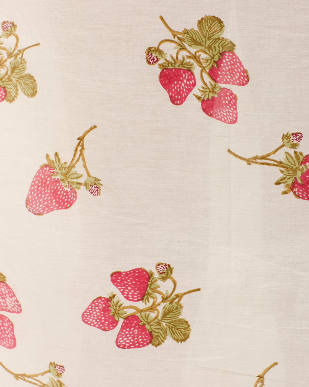 The Kay Strawberry Dot Dress features white fabric adorned with illustrated strawberries and green leaves, making it ideal for a charming strawberry motif look.