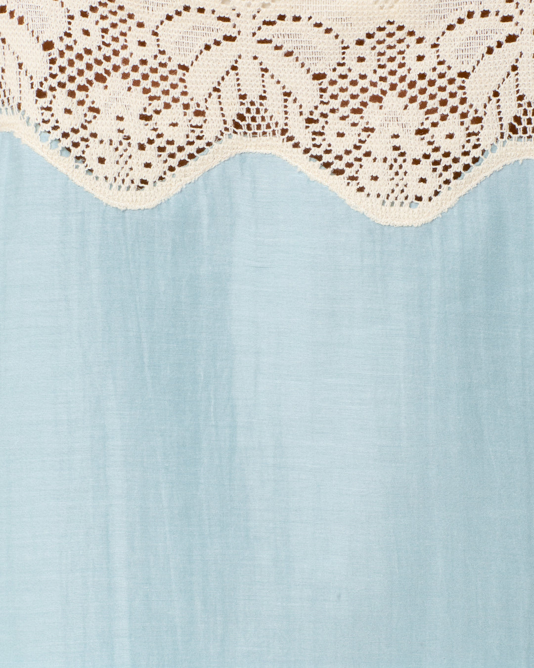 The Mia Sky Prima Lace Top features white floral lace over a light blue fabric, making it the perfect inspiration for your stylish summer look.