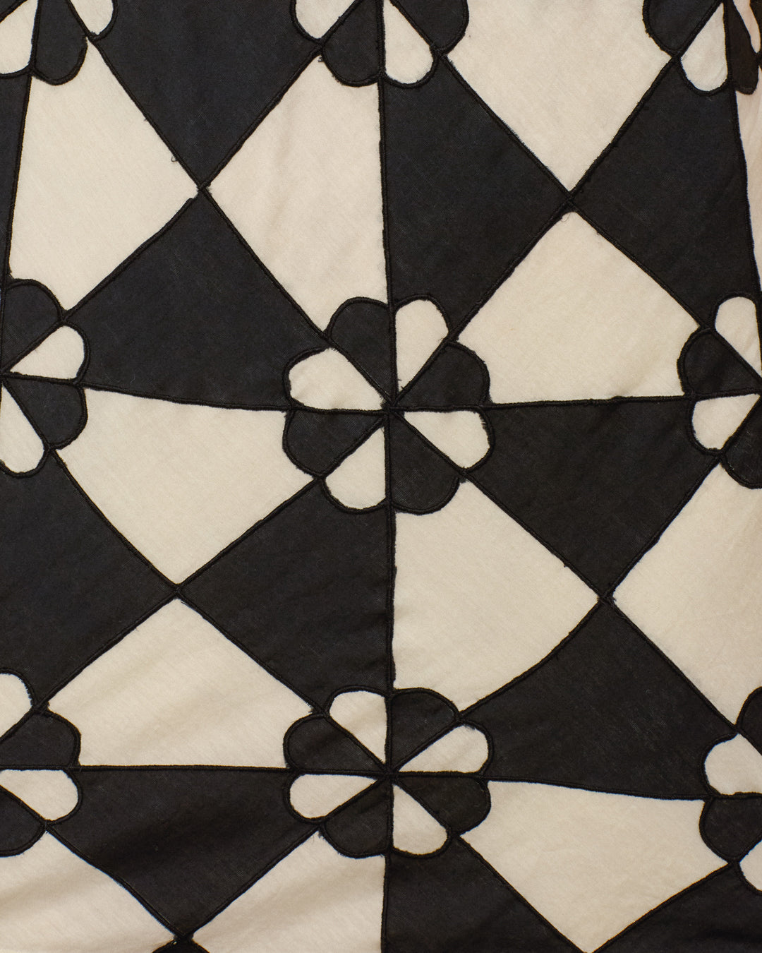 The Vita Onyx Jubilee Dress features a black and white geometric diamond pattern with flower-like motifs at the intersections, evoking vintage shift dress style.