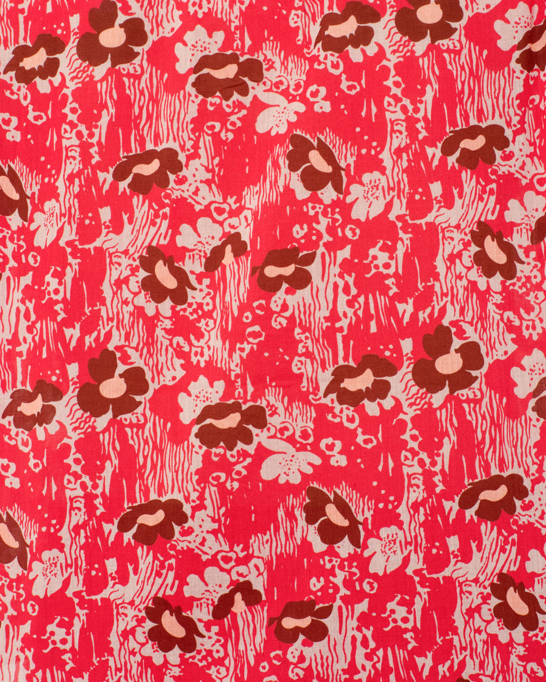 The Winnie Rougewood Shirt is a red cotton voile top with puff shoulders and an abstract floral pattern in brown and cream, featuring scattered flowers and irregular shapes on a textured background.