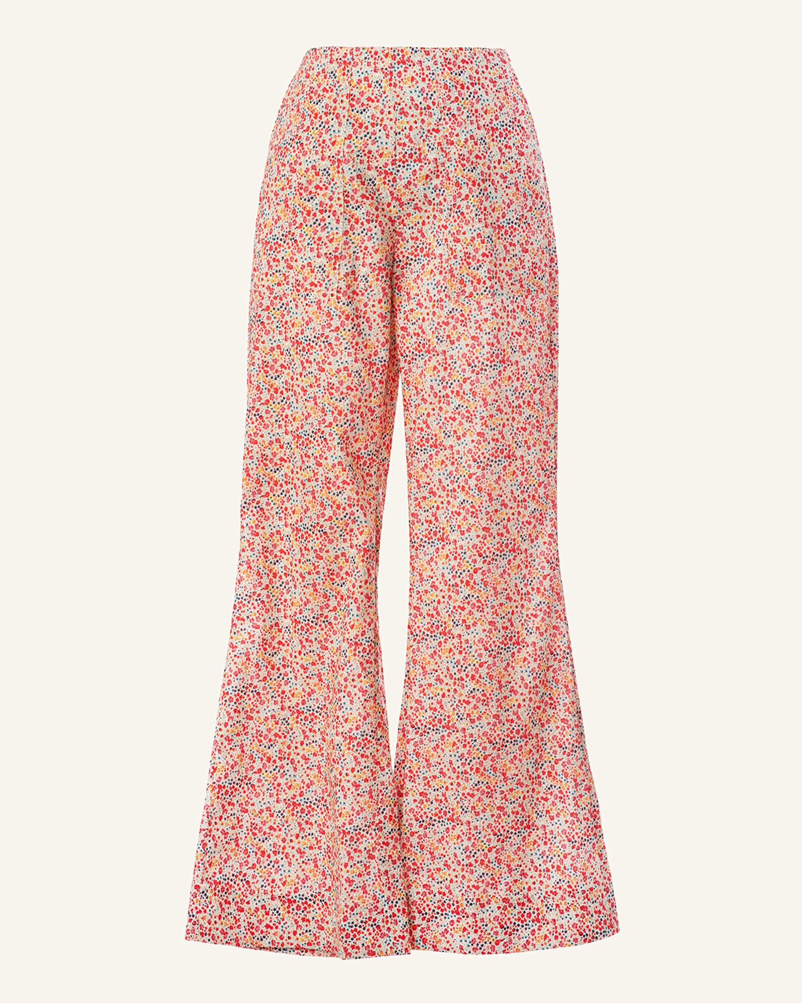 The Charlie Liberty Garden Pant, made from soft cotton, features a breathtaking red floral design on an off-white background. With a high waist and wide-leg, flowy fit, these pants are a relaxed yet stylish addition to any wardrobe.