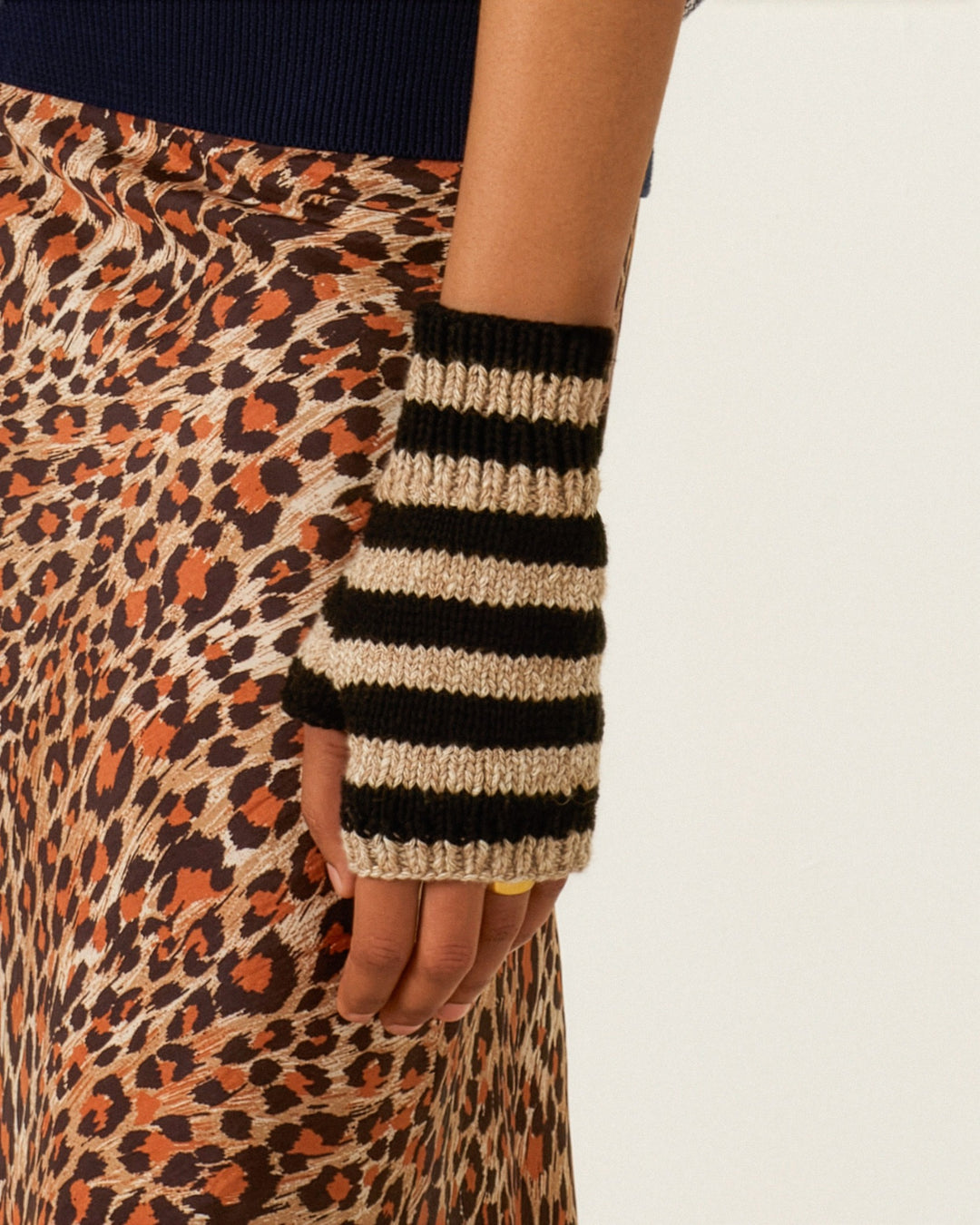 A person wearing Venus Zebra Stripe Gloves and a brown leopard print skirt.